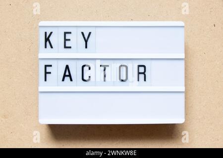 Lightbox with word key factor on wood background Stock Photo