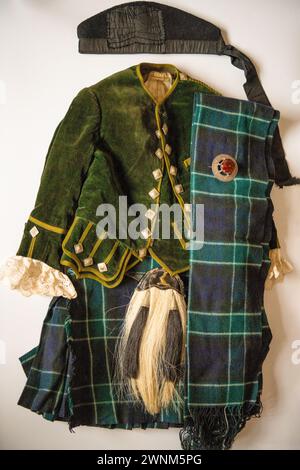 Four year's olds vintage Scottish clan outfit, of about 1910. Tartan unknown with Scottish Brooch, Kilt, Jacket, Glengarry Bonnet, Sash & Sporran. Stock Photo