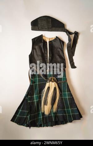 A Four year's olds vintage clan outfit, about 1910, showing the vest and kilt are one piece. With the glengarry bonnet and sporran. Stock Photo