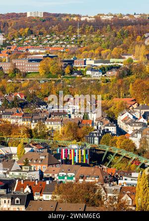 City view in sunny weather with a colourful building and surrounding autumnal forests, suspension railway, Junior Uni, Barmen, Wuppertal, North Stock Photo
