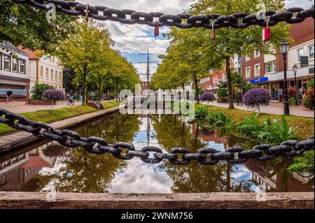 View of a city canal with chains in the foreground and reflection of the sky in the water, Papenburg, Emsland, Lower Saxony Stock Photo