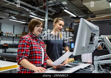 Professional female employees working in a printing house Stock Photo