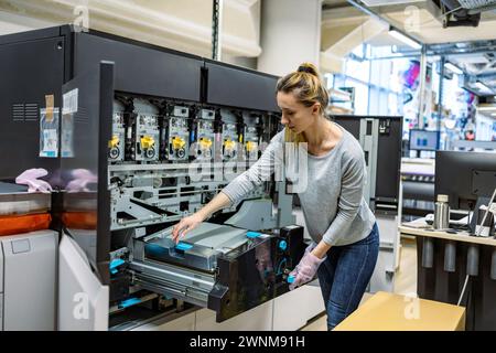 Woman working in a printing factory Stock Photo