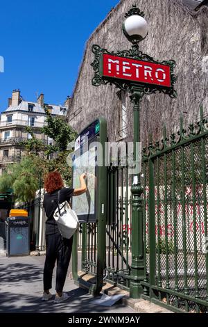 Tourist at the metro stop consulting the city map, Paris, France, Europe, M.R. Stock Photo