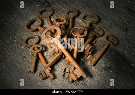 rusty old keys on a wooden table Stock Photo