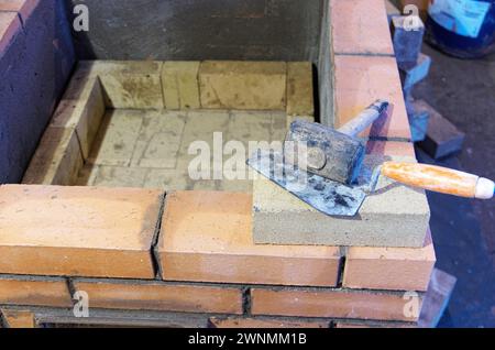 construction of brick ovens. brick stove for sauna. heating stone stove. Stock Photo