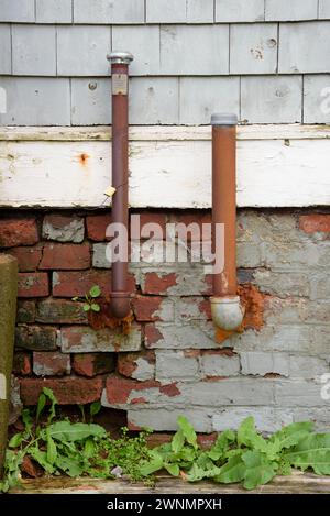 Rusty oil and vent pipes used to pump heating oil in the tank of a domestic furnace. Stock Photo