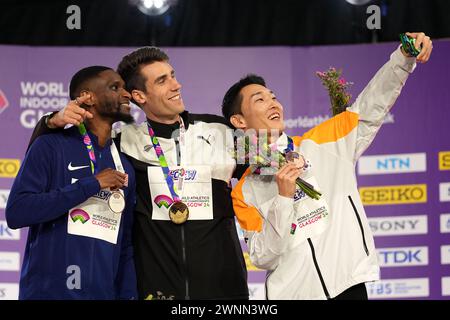 USA's Shelby McEwen, silver, New Zealand's Hamish Kerr, gold, and Korea's Sanghyeok Woo, bronze, (left-right) take a selfie on the podium for the Men's High Jump during day three of the World Indoor Athletics Championships at the Emirates Arena, Glasgow. Picture date: Sunday March 3, 2024. Stock Photo