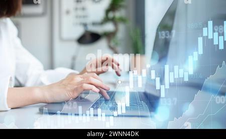 Close-up of a professional woman's hands typing on a laptop keyboard in an office Stock Photo