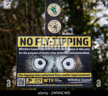 No fly-tipping sign with warning of camera surveillance and potential fines in Wiltshire area. Stock Photo