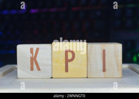Photo of words with wooden block objects arranged into the word "KPI" in English Stock Photo