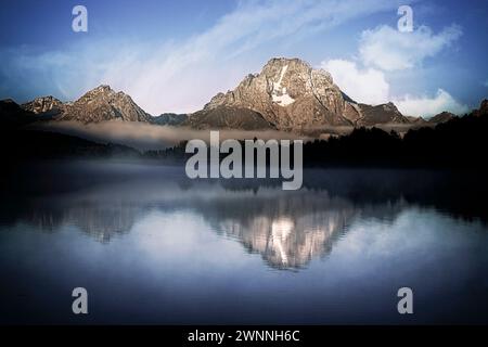 Mount Moran reflects in the still waters at Oxbow Bend along the Snake River in Grand Teton National Park in Wyoming. Stock Photo