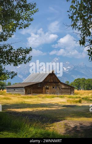 Peaks of the Grand Tetons rise up behind the T. A. Moulton Barn on Mormon Row in the Historic District of the Grand Teton National Park in Wyoming Stock Photo