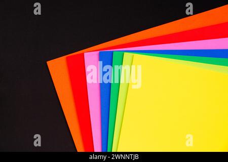 Black background with sheets of rainbow colored foam Stock Photo