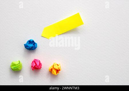 Yellow note next to other crumpled and discarded ones Stock Photo
