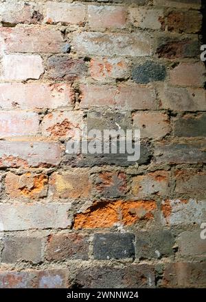 Crumbling Indoor Vintage Brick Wall with Red Bricks Stock Photo