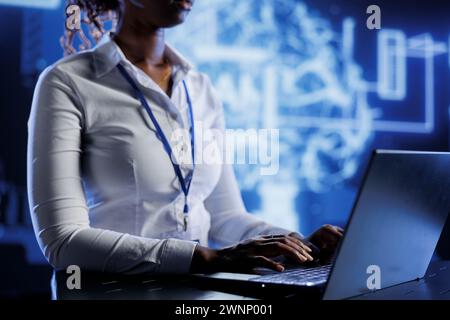 Certified technician developing artificial intelligence neural networks nodes modeled after human brain. Experienced worker setting up AI machine learning accurately making predictions using data Stock Photo