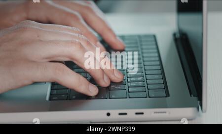 Man hands typing on laptop close up. Online project, report research at desk. Planning, business, freelancer student using laptop studying online working from home in internet. Blue toning side view Stock Photo