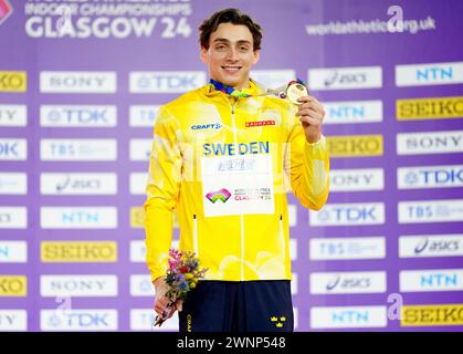 Sweden's Armand Duplantis celebrates gold on the podium for the Men's Pole Vault during day three of the World Indoor Athletics Championships at the Emirates Arena, Glasgow. Picture date: Sunday March 3, 2024. Stock Photo