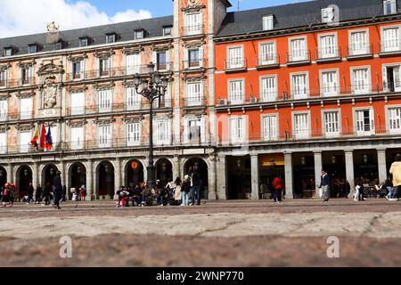 Madrid, Spain, 27 February 2024 Plaza Mayor central square in Spanish capital. Red building facade in historical city center. Travel destination. Stock Photo