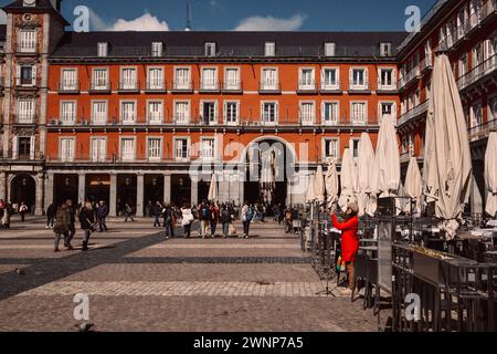 Madrid, Spain, 27 February 2024 Plaza Mayor central square in Spanish capital. Red building facade in historical city center. Travel destination. Stock Photo