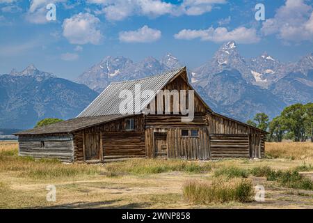 Peaks of the Grand Tetons rise up behind the T. A. Moulton Barn on Mormon Row in the Historic District of the Grand Teton National Park in Wyoming Stock Photo