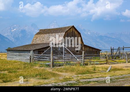 Peaks of the Grand Tetons rise up behind the John Moulton Barn on Mormon Row in the Historic District of the Grand Teton National Park in Wyoming Stock Photo