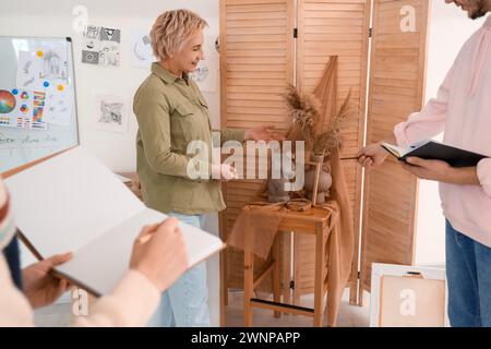 Female art teacher giving lecture to student at school Stock Photo - Alamy