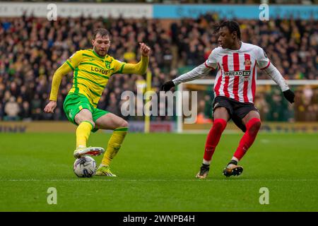 Romaine Mundle of Sunderland is put under pressure from Jack Stacey of ...