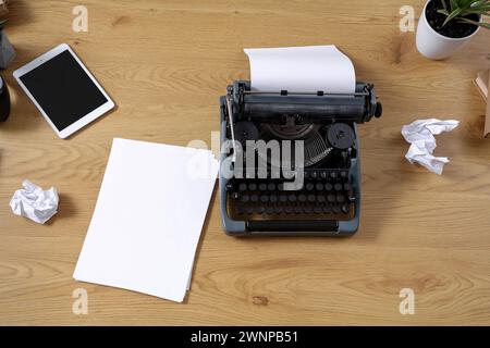 Vintage typewriter with paper sheets on wooden table, top view Stock Photo