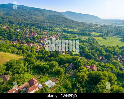 Aerial landscape of the mountains and houses with green fields and scenery in village. Stock Photo
