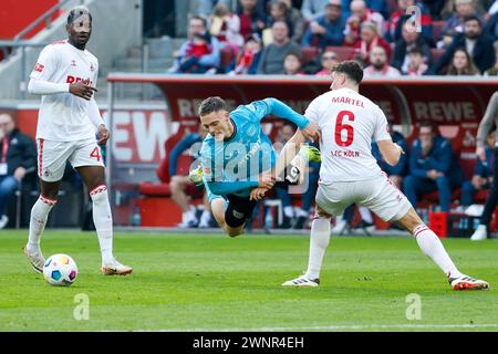 Cologne, Germany. 3rd Mar, 2024. Eric Martel (R) of FC Cologne vies with Florian Wirtz (C) of Bayer 04 Leverkusen during the first division of Bundesliga match between FC Cologne and Bayer 04 Leverkusen in Cologne, Germany, March 3, 2024. Credit: Joachim Bywaletz/Xinhua/Alamy Live News Stock Photo