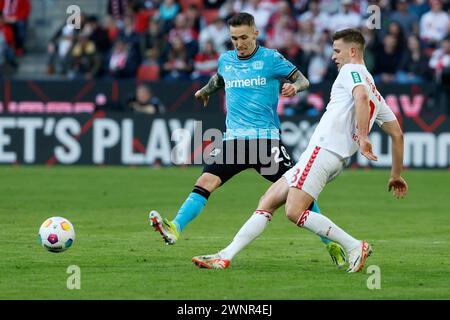 Cologne, Germany. 3rd Mar, 2024. Rasmus Carstensen (R) of FC Cologne vies with Alejandro Grimaldo of Bayer 04 Leverkusen during the first division of Bundesliga match between FC Cologne and Bayer 04 Leverkusen in Cologne, Germany, March 3, 2024. Credit: Joachim Bywaletz/Xinhua/Alamy Live News Stock Photo