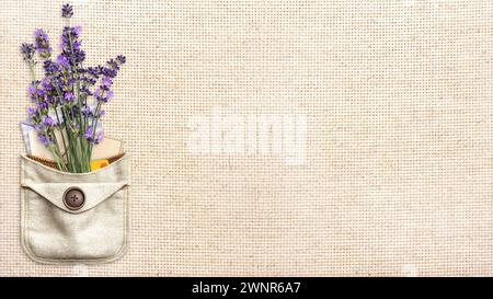 Purple lavender flower and retro envelopes in pocket. Bunch of fresh lavandula flowers in pouch on canvas texture backdrop. Horizontal eco background Stock Photo