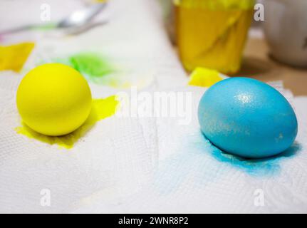 Blue and yellow colored eggs on white napkins. Easter, handmade Stock Photo