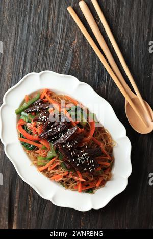 Japchae Korean Noodle Topped with Bulgogi Beef, Top View Stock Photo