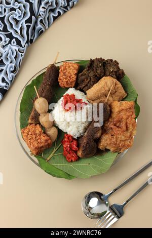 Nasi Jamblang or Nasi Campur Cirebon, Steamed Rice Wrapped with Teak Leaves and Serve with Various Side Dish Stock Photo
