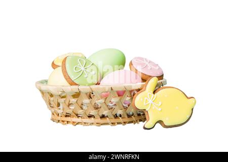 Colorful easter cookies in basket with Multi colors Easter eggs isolated on white background. Pastel color Easter eggs. holiday concept. Stock Photo