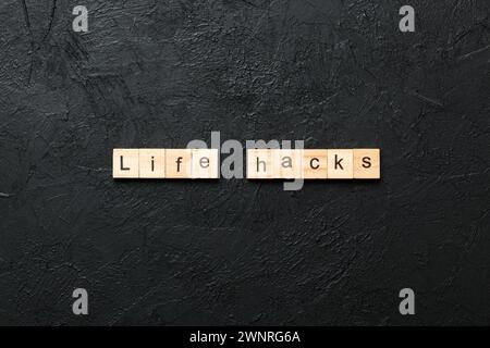life hacks word written on wood block. life hacks text on table, concept. Stock Photo