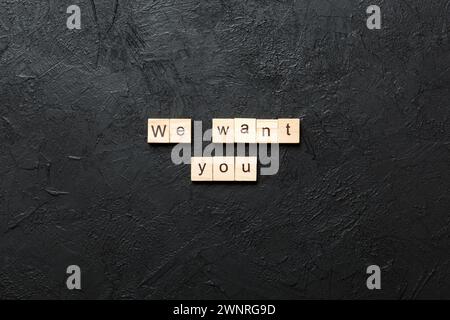 We Want You word written on wood block. We Want You text on cement table for your desing, concept. Stock Photo