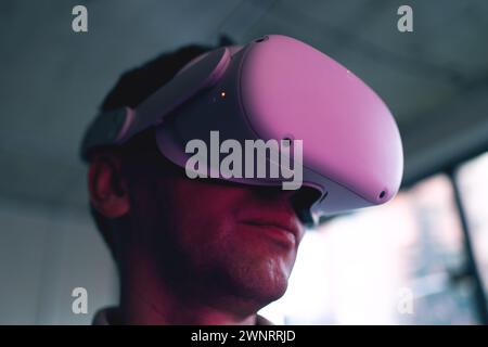 Man immersed in virtual reality with modern VR headset, exploring digital worlds.  Stock Photo