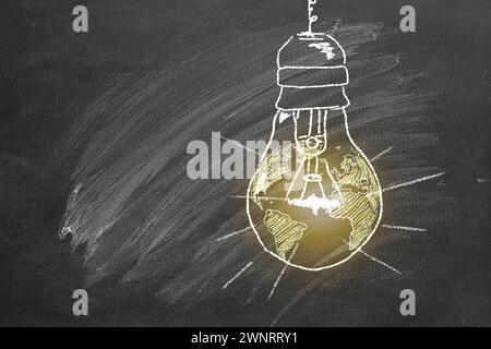 A light bulb with a globe inside, drawn in chalk on a school board. Earth hour concept. Save the world. Save our planet. Stock Photo