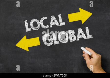 Local or Global written on a blackboard Stock Photo