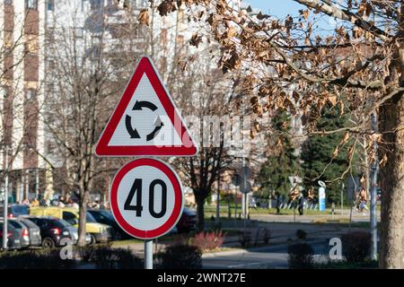 Traffic signs near roundabout, roundabout danger sign and speed limit 40 Stock Photo