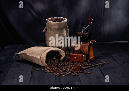 Photo of coffee beans in a coffee sack next to a coffee grinder Stock Photo