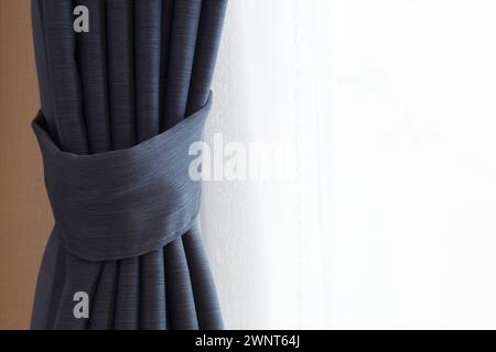 Abstract background folded blue hotel curtains with white net sheers Stock Photo