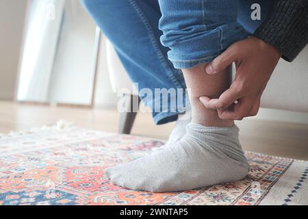 man suffering from itching skin on his feet  Stock Photo
