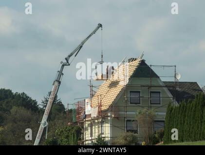a roofer at work on a building, roof work and construction roofer at work on a building Stock Photo