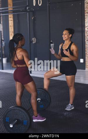 Two fit women are engaged in a workout session at a gym Stock Photo