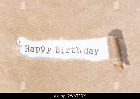 Happy Birthday message. Brown paper torn stripe with text on white paper background Stock Photo